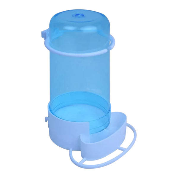 Comedero Pedrós #6 transparente con semillas en su interior, listo para alimentar aves de ornato.